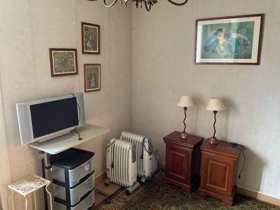 a television and a radiator in a small room