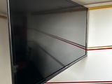 a flat screen tv hanging on a wall in a room