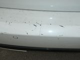 a close up of a white car with rust on it
