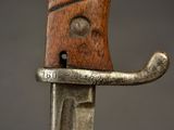 a close up of a knife with a wooden handle