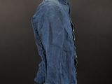 a blue jean jacket on a mannequin stand against a black background