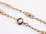 gold plated chain with oval links on a white background