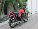 a red motorcycle parked on the side of the road