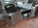 stainless steel counter top with dishes and pans on top of it