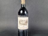 a bottle of wine with a brown label sitting on top of a table