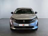 the front view of a silver car parked in a showroom