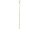 a white floor lamp with a white shade on top of it