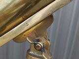 a gold telescope that is on top of a table