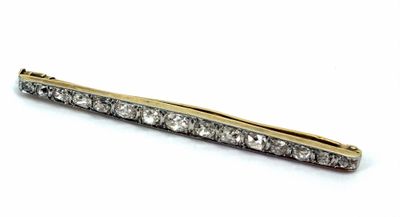 an image of a gold and diamond hair clip on a white background