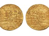 two gold coins with arabic writing on them