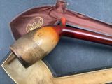 a pipe and a pipe holder sitting on a table