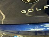 a close up of a golf logo on the back of a car
