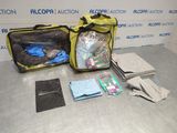 a bag of items sitting on a table next to a pair of gloves and a pair of gloves