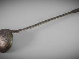 a close up of a spoon with a metal handle on a table