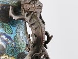a blue and gold vase with a lizard on it