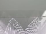 a clear glass bowl with a pattern on it
