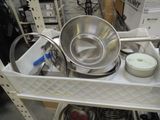 many pots and pans sitting on a shelf in a store