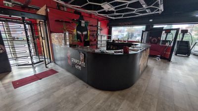 an image of a gym with a bar and a treading machine