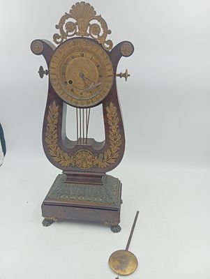 une horloge posée sur une table à côté d'une autre horloge