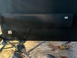 a cat that is laying on the floor next to a tv
