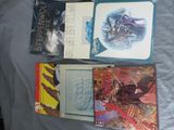 many books that are sitting on a bed together