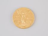 an image of a gold coin sitting on top of a white surface