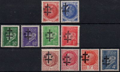 several different colored stamps with crosses on them on a black surface