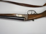 an old rifle with a wooden handle on a white surface