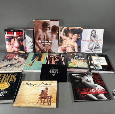 several books are arranged on a table in front of a gray background