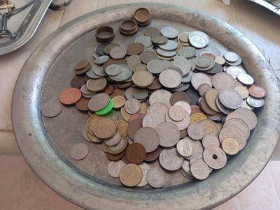 a bowl full of coins sitting on a table