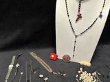 lot of jewelry including necklaces, bracelets, brooches, pins, and pins