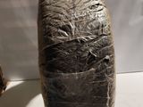 a piece of plastic wrapped around a vase on a table