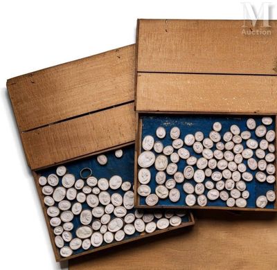 two boxes filled with white buttons on a wooden table