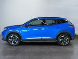 a blue nissan c - hr suv parked in a garage