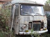 an old van that is sitting in the grass