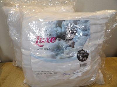 a bag of white pillows on a table in a room