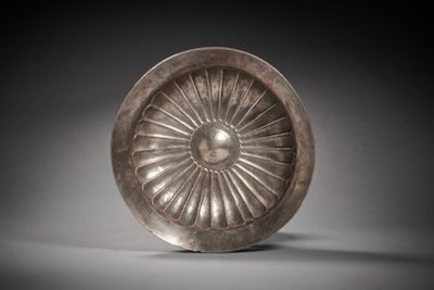 an image of a silver plate with a flower design on it