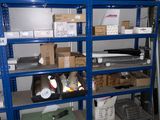 a blue shelving with lots of boxes on top of it