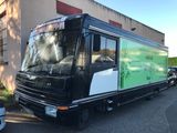 a black and white bus parked in front of a building