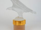 an image of a glass bird on top of a jar
