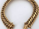an image of a gold bracelet with a clasp on it