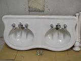 two sinks that are sitting on the floor in the bathroom