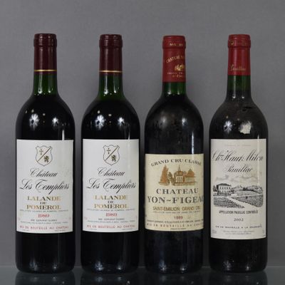 three bottles of red wine are lined up on a table