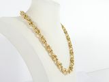 a gold chain necklace on a mannequin neck