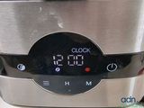 a digital clock on the side of a slow cooker