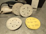 three discs of sand are sitting on a table next to a sander