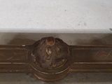 a white marble bench with a metal base and a clock on the top of it