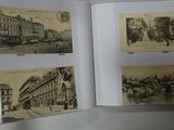 a person holding a book open to show pictures of a city