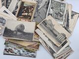 a pile of old postcards sitting on a table