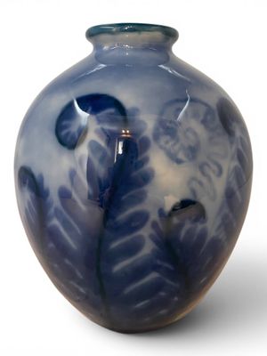 a blue and white vase with a bird on it